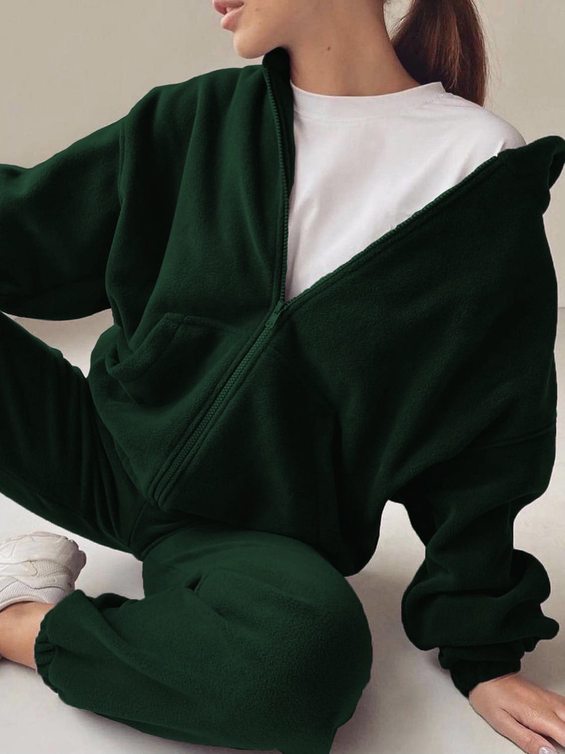 Dark green fleece zip-up hoodie with white t-shirt and matching joggers.