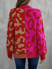 Split leopard knit sweater with statement sleeves in rose/red and blue/green color-blocked design.