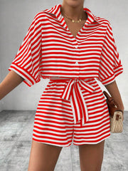 Red and white striped shirt romper with button front and self-tie belt.