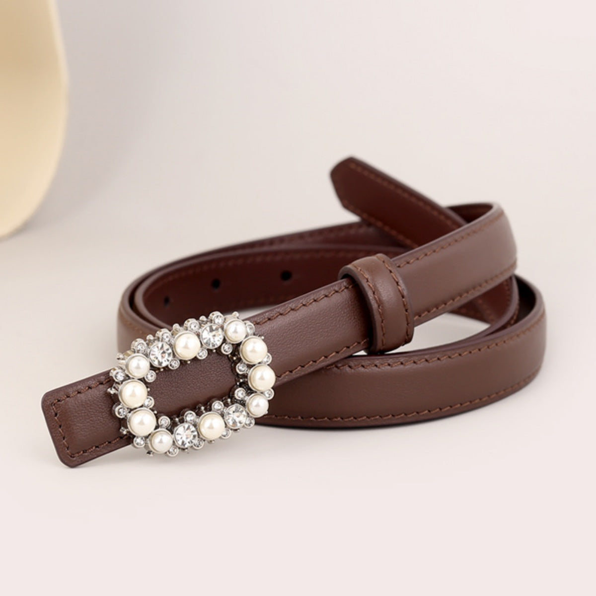 Brown leather belt with pearl and rhinestone oval buckle detail