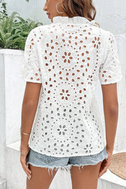 White embroidered eyelet blouse with short sleeves and ruffled collar, shown from the back.