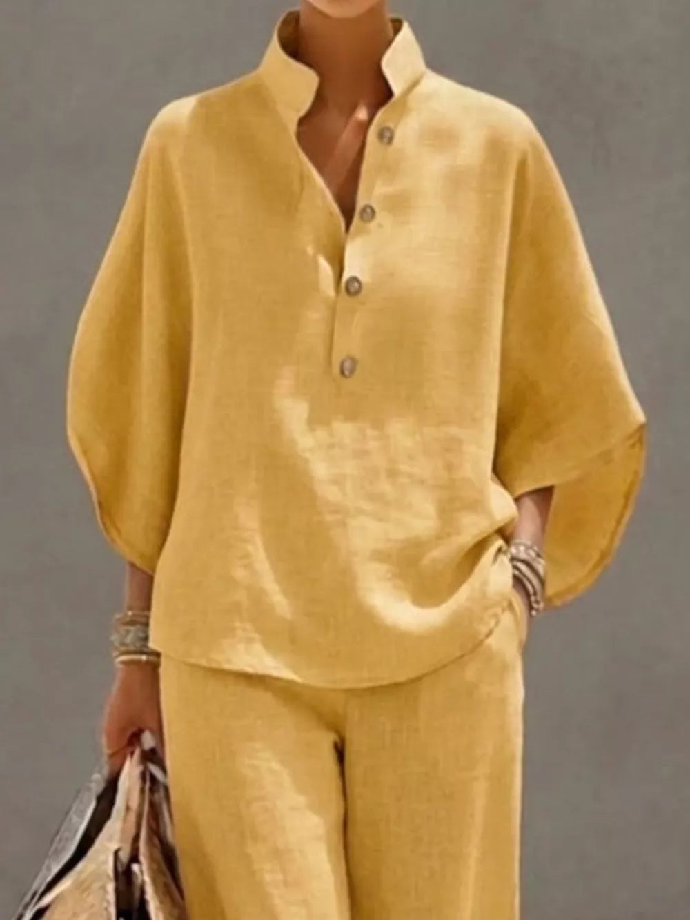 Yellow button-down loungewear set with wide sleeves and a stand collar.