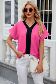 Hot Pink blouson top with black V-neck contrast panel and cuffed short sleeves.