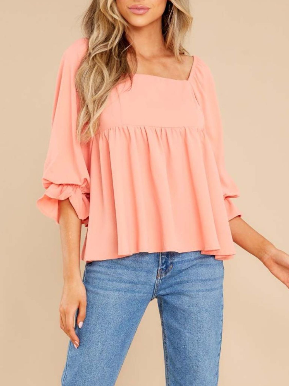 Watermelon pink babydoll blouse with square neckline and ruffled sleeves.