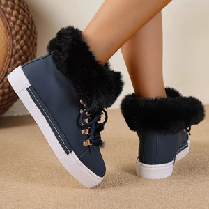 Dark blue round-toe platform boots with fluffy black faux fur cuffs and white soles.