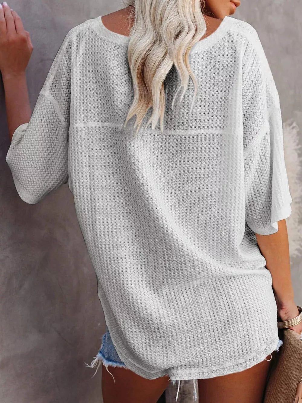 Waffle knit relaxed v-neck t-shirt in grey with short sleeves and a curved hem.