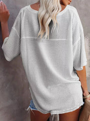 Waffle knit relaxed v-neck t-shirt in grey with short sleeves and a curved hem.