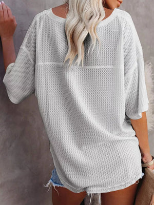 Waffle knit relaxed v-neck t-shirt in grey with short sleeves and a curved hem.