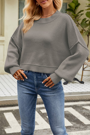 Boxy ribbed knit sweater in light gray with crewneck and dropped shoulders.