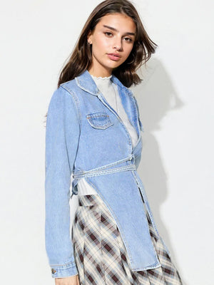 Medium wash denim wrap jacket with asymmetric hem and tie waist.
