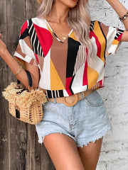 Geometric print V-neck blouse with short sleeves and a multicolor abstract pattern.