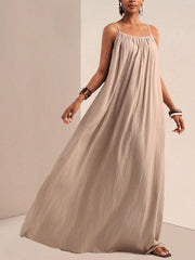 Khaki maternity swim dress with spaghetti straps and gathered neckline, flowing maxi length.