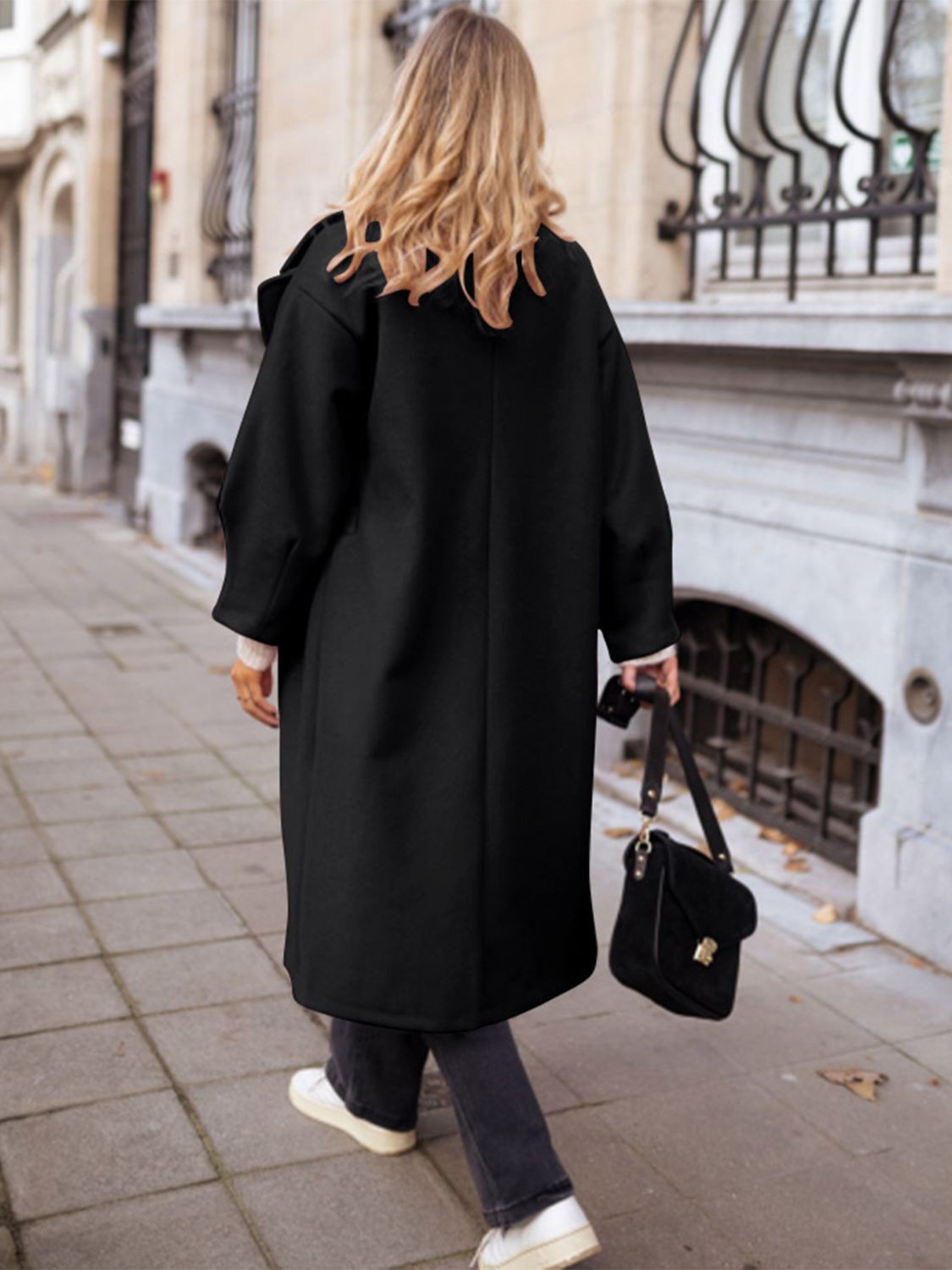 Black oversized wool-blend cocoon coat with wide sleeves and a relaxed fit.