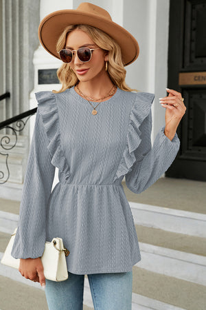 Light blue textured peplum blouse with ruffle details and long sleeves.