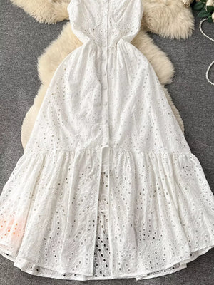 White lace-embroidered cami dress with tiered skirt and button front detail.