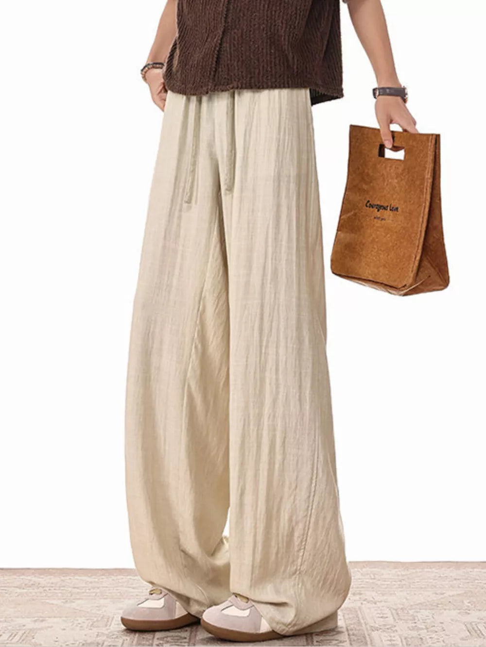 Khaki relaxed fit drawstring sweatpants with wide legs and a casual style.