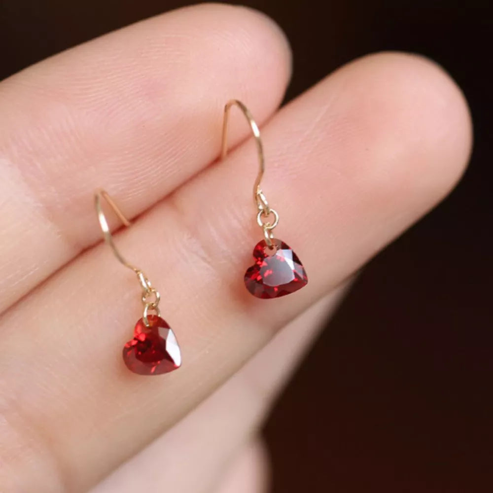 Dainty red heart-shaped zircon drop earrings with gold hooks.