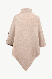 Button-detail turtleneck knit poncho in tan with buttoned sleeves and a textured acrylic knit.