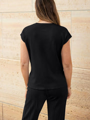 Black seamed knit top with cap sleeves and wide-leg pants with vertical seams.