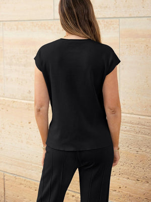 Black seamed knit top with cap sleeves and wide-leg pants with vertical seams.