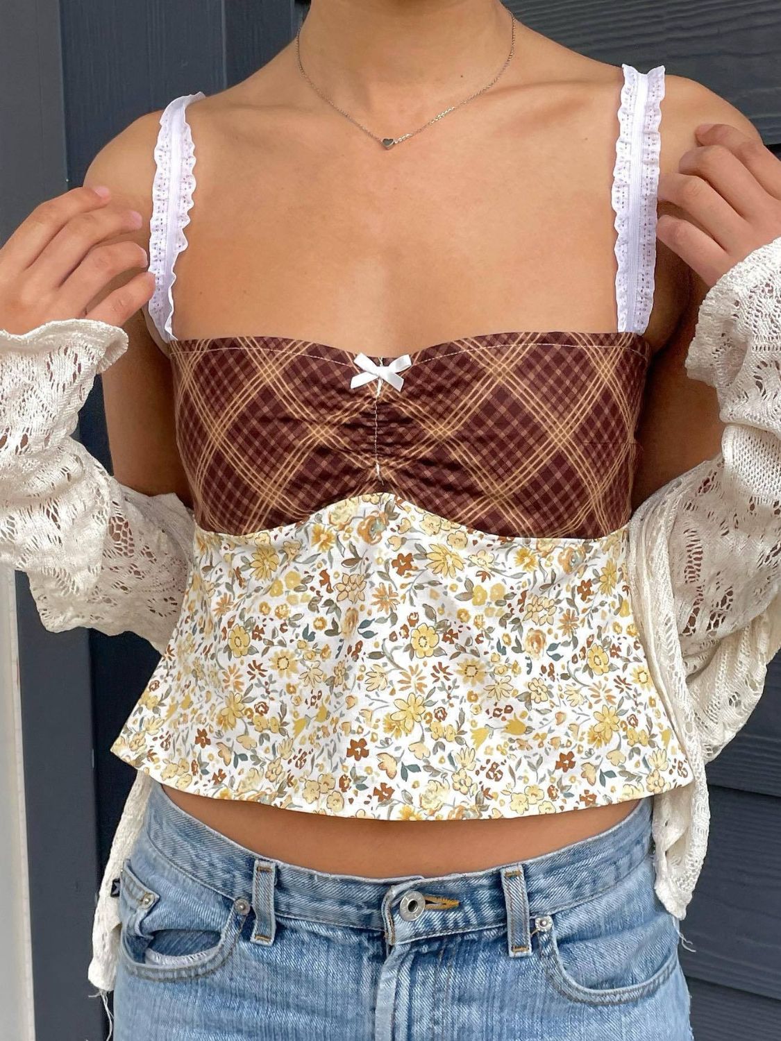 Mixed print corset cami with white lace straps and a small bow detail.