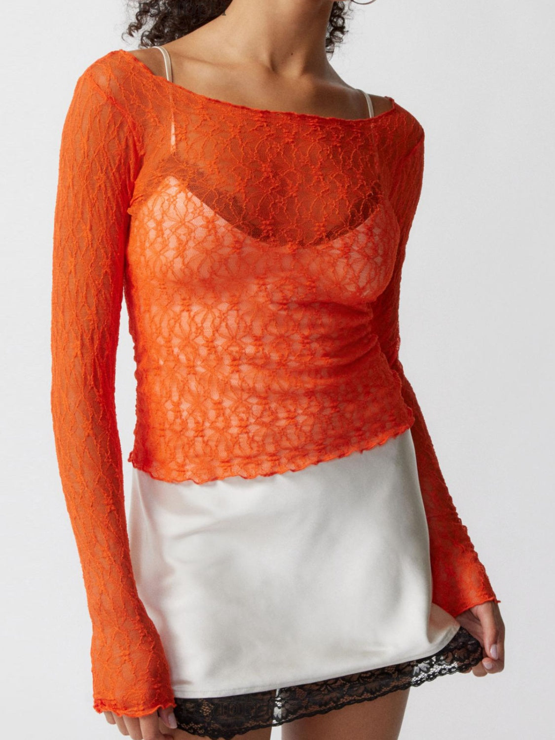 Orange floral lace long sleeve top with scalloped edge detail.