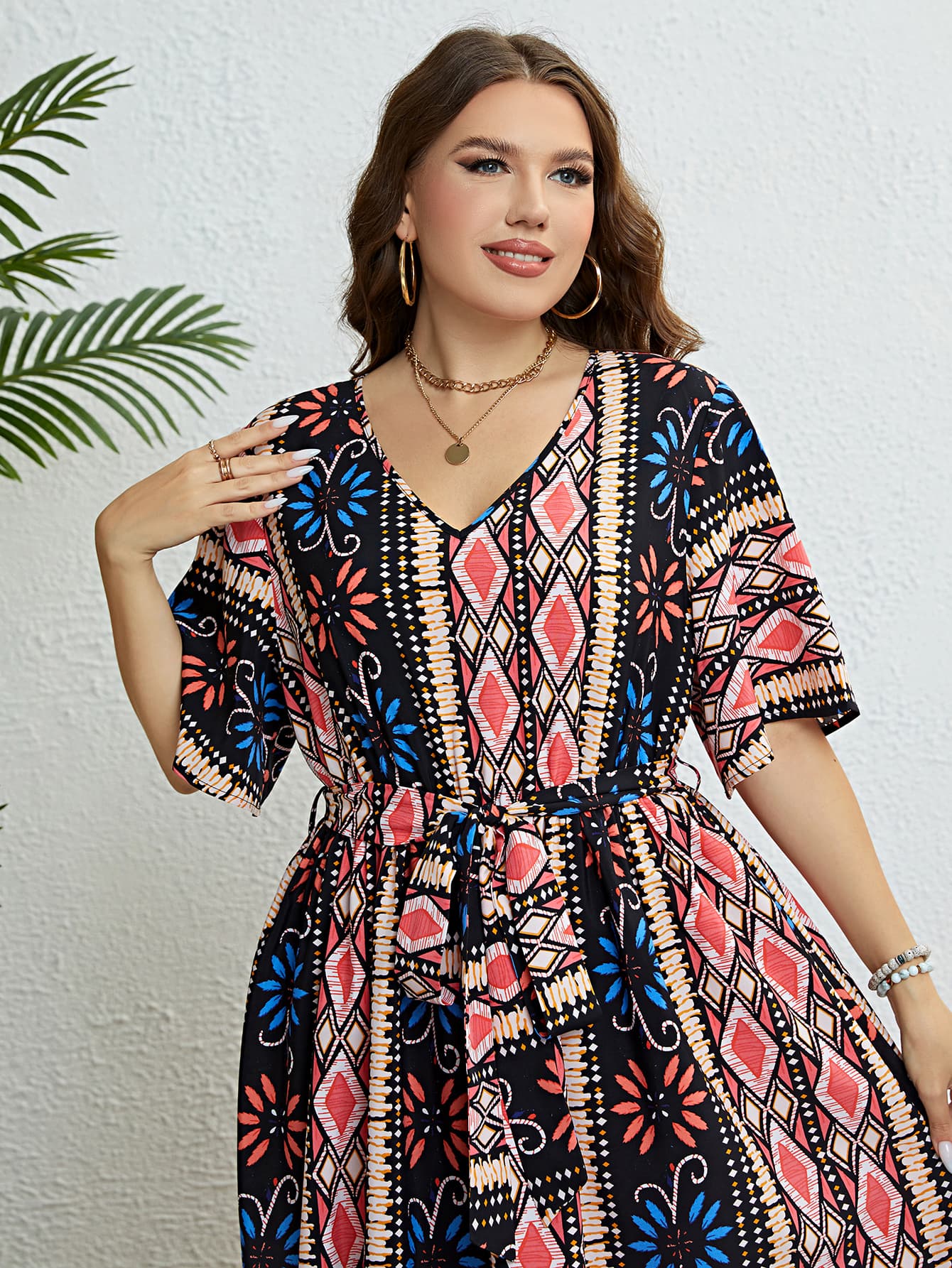 Multicolor geometric print midi dress with V-neck, short sleeves, and tie waist.