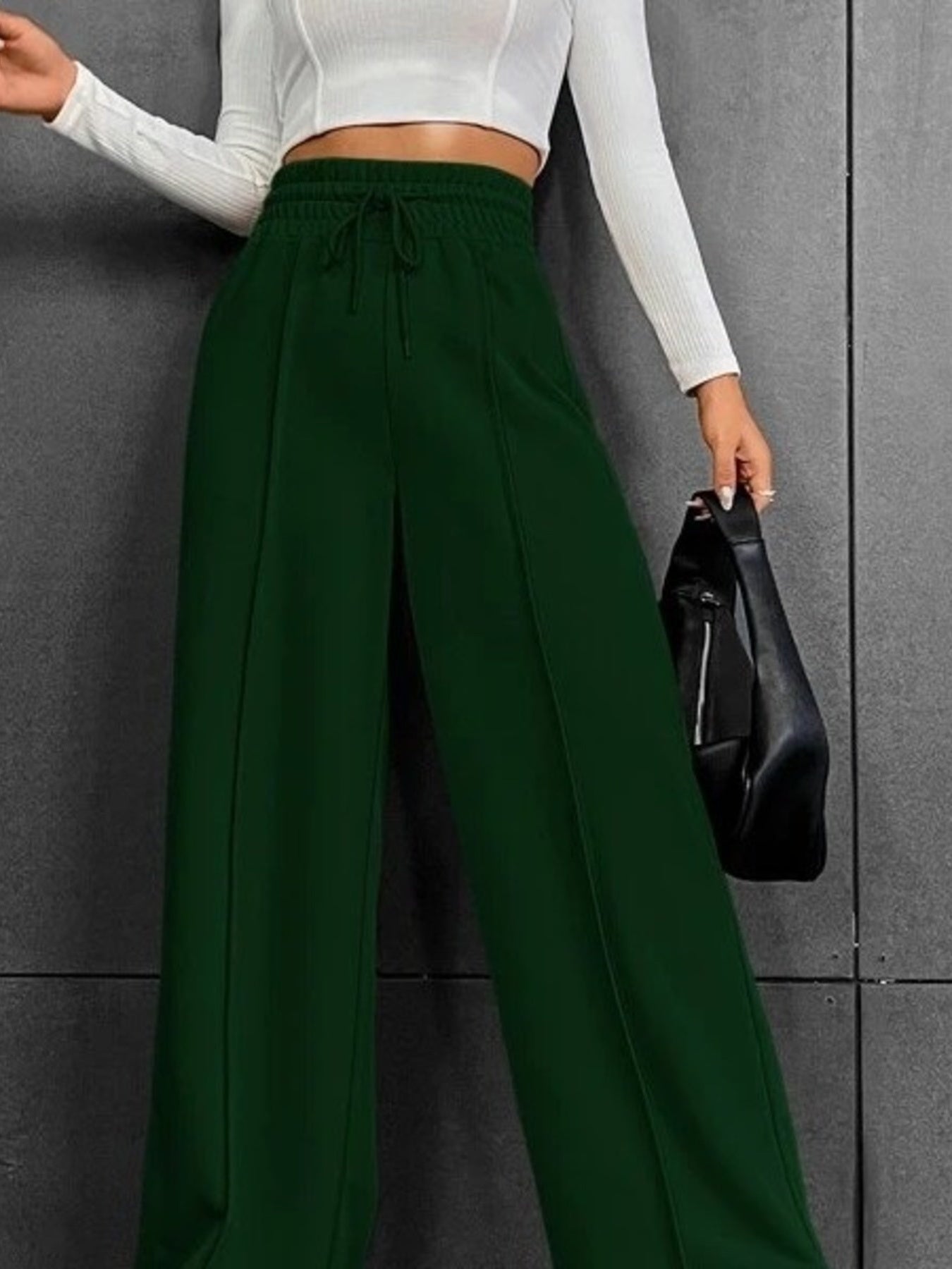 Dark green wide-leg sweatpants with drawstring waist and front seam detail.