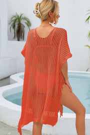 Orange open-knit beach cover-up with V-neck, short sleeves, and fringe hem.