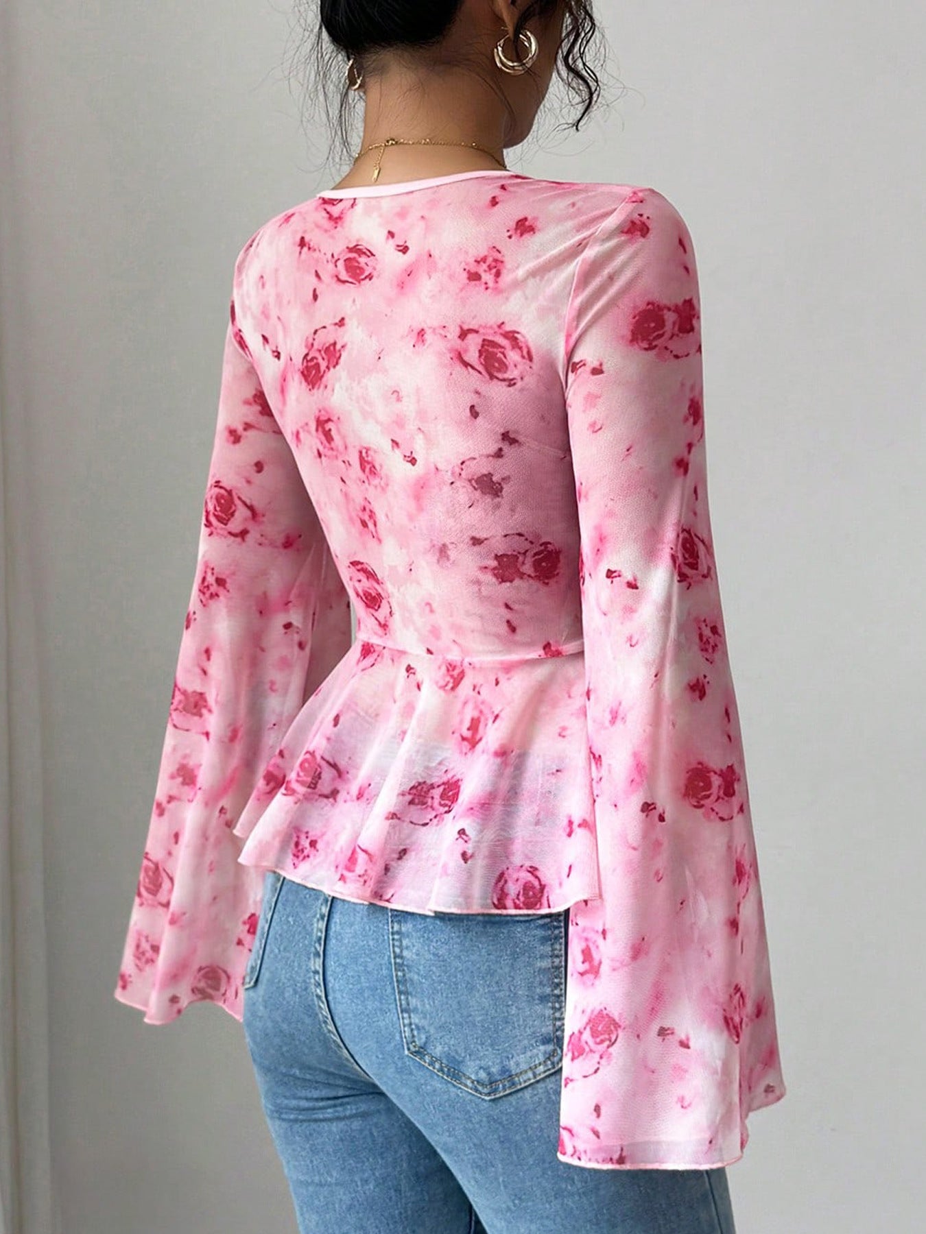 Pink floral chiffon blouse with bell sleeves and peplum hem