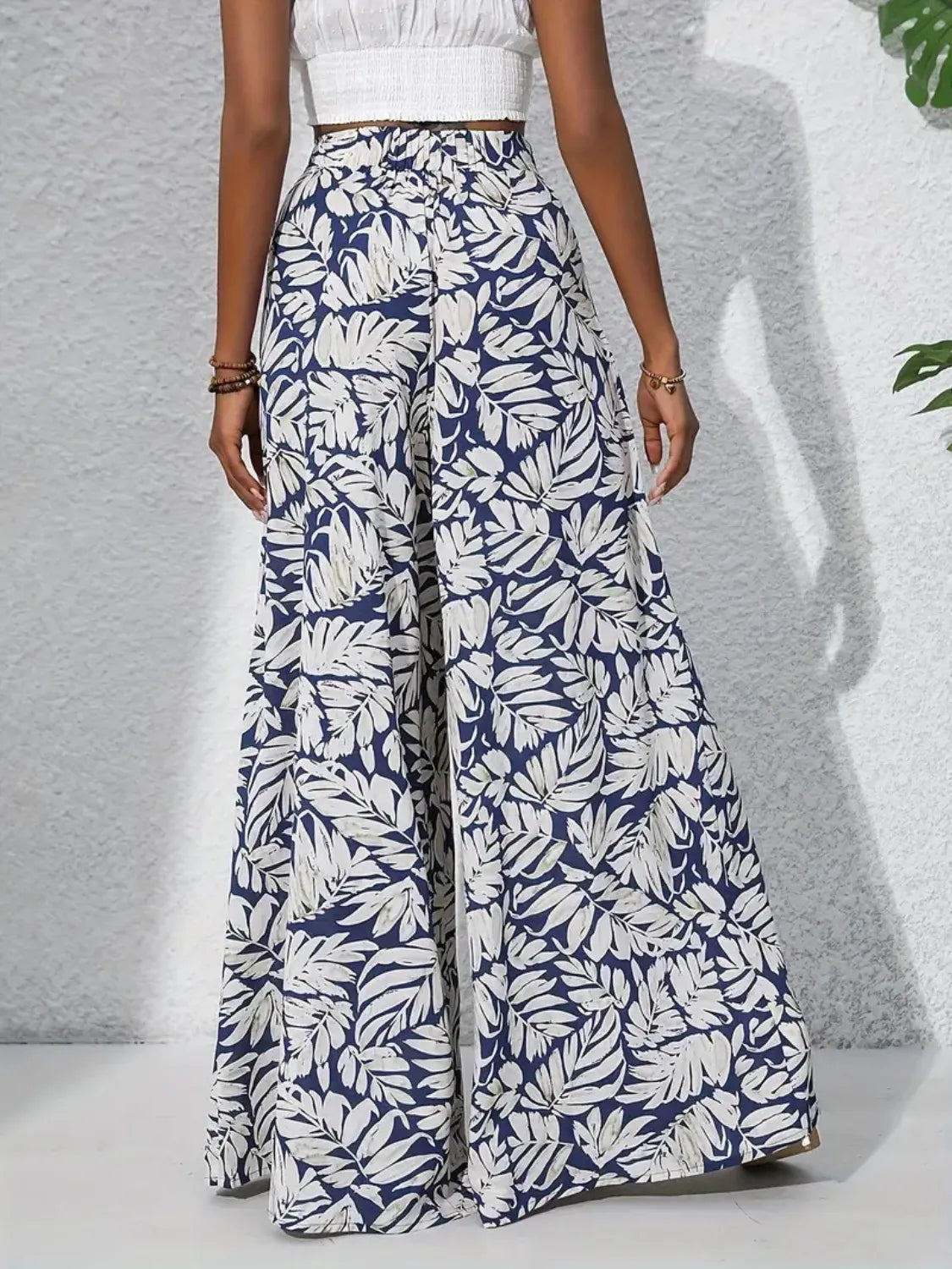 Palazzo trousers in navy with white tropical leaf print, 100% polyester, wide leg.