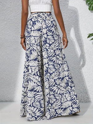 Palazzo trousers in navy with white tropical leaf print, 100% polyester, wide leg.