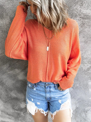 Orange open-knit V-neck drop shoulder sweater with a relaxed fit.