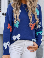 Navy knit sweater with multicolor bow motif, crew neck, long sleeves.
