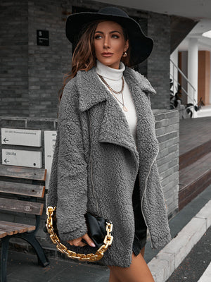 Gray teddy moto jacket with asymmetrical zip and collared neckline.