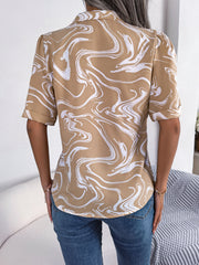Khaki swirl print camp collar blouse with short sleeves and rolled cuffs.
