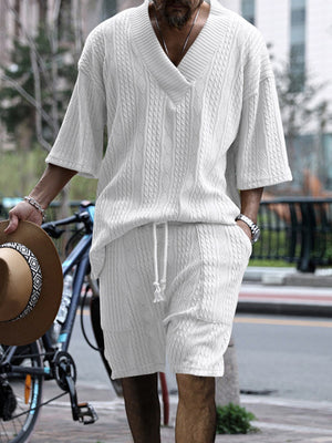 White cable-knit v-neck two-piece set with drawstring shorts and short sleeves.