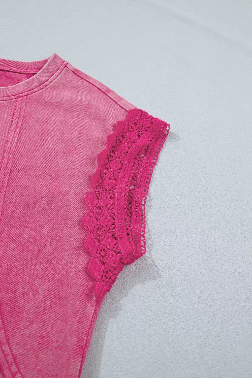 Pink mineral wash t-shirt with cap sleeves and intricate lace trim detail.