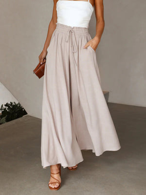 Gathered waist wide-leg palazzo pants in eggshell with drawstring and pockets.