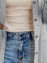 Gray button-down cotton cardigan over a cream waffle knit top and distressed jeans.