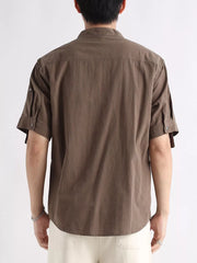 Brown cotton button-down short sleeve shirt with roll-tab sleeves and mandarin collar.