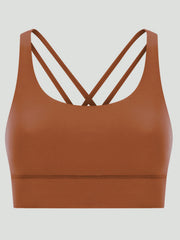 Caramel sports bra with crisscross back straps and a scoop neckline.