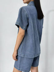 Button-up denim top and shorts set in sky blue with collared neckline and short sleeves.