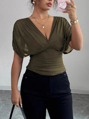 Army green ruched surplice dolman sleeve top with a deep V-neck.
