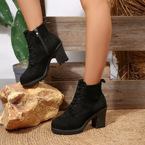Black suede lace-up ankle boots with block heel and side zipper detail.