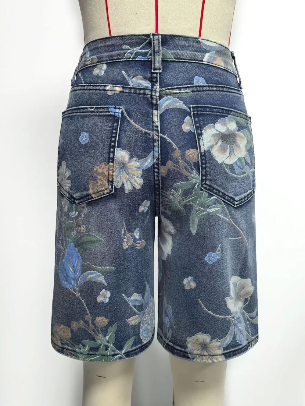 Blue denim shorts with a botanical print and relaxed fit.
