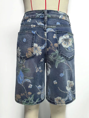 Blue denim shorts with a botanical print and relaxed fit.