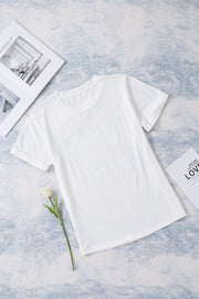 White graphic t-shirt with floral accents and short sleeves.