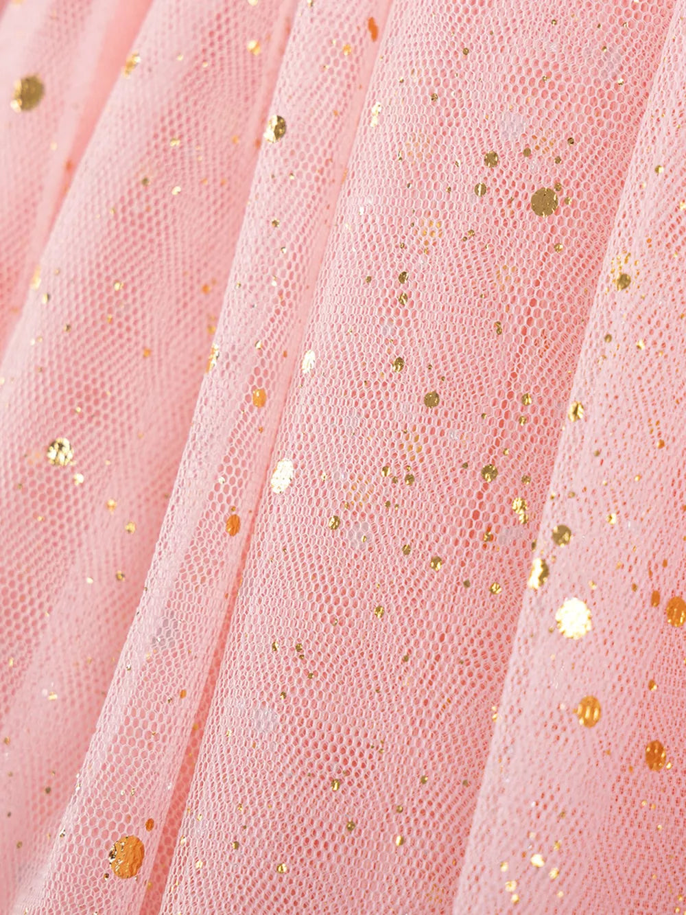 Pink tulle baby dress with gold glitter dots, close-up detail.