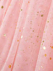 Pink tulle baby dress with gold glitter dots, close-up detail.